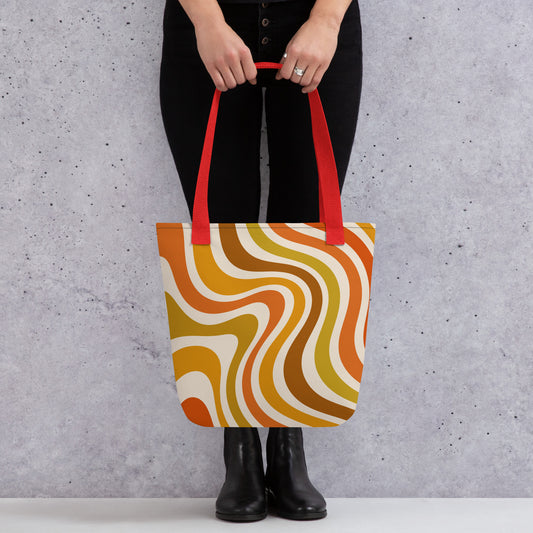Retro 70s groovy wavy pattern in orange, mustard, brown, and cream printed on a durable polyester shoulder tote bag.