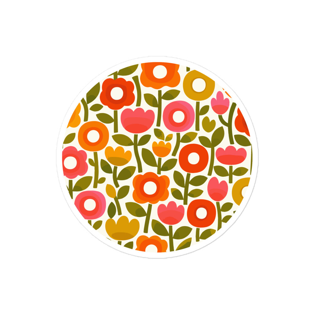 Retro 1970s flower power pattern vinyl sticker featuring geometric orange, pink, and yellow flowers with green leaves