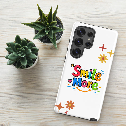 Smile More, bubbly lettering with a yellow sun-smile and pink heart on a black Samsung Galaxy phone case.