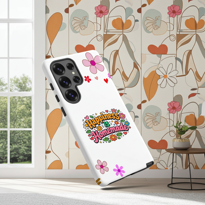 Groovy Samsung Galaxy case with 'Happiness is Homemade' text, surrounded by 70s flowers and hearts on a black background.
