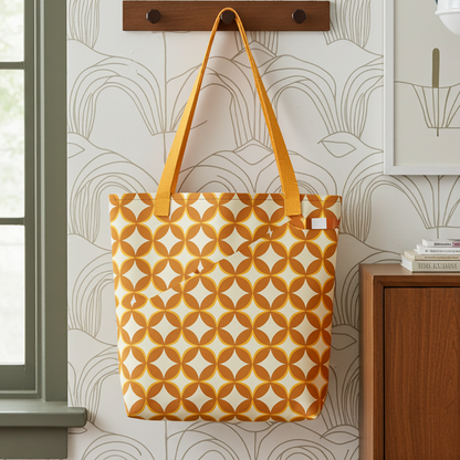Repeating geometric pattern of interlocking orange and cream circles and stars in a 1970s retro vintage style.
