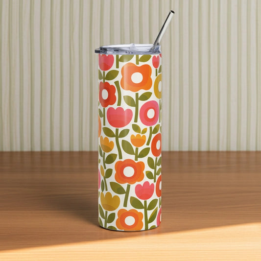 Retro 1970s flower power pattern travel tumbler featuring geometric orange, pink, and yellow flowers with green leaves