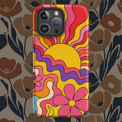 Vibrant 1970s psychedelic iPhone case featuring a wavy retro sunburst sunset surrounded by colorful groovy flowers.