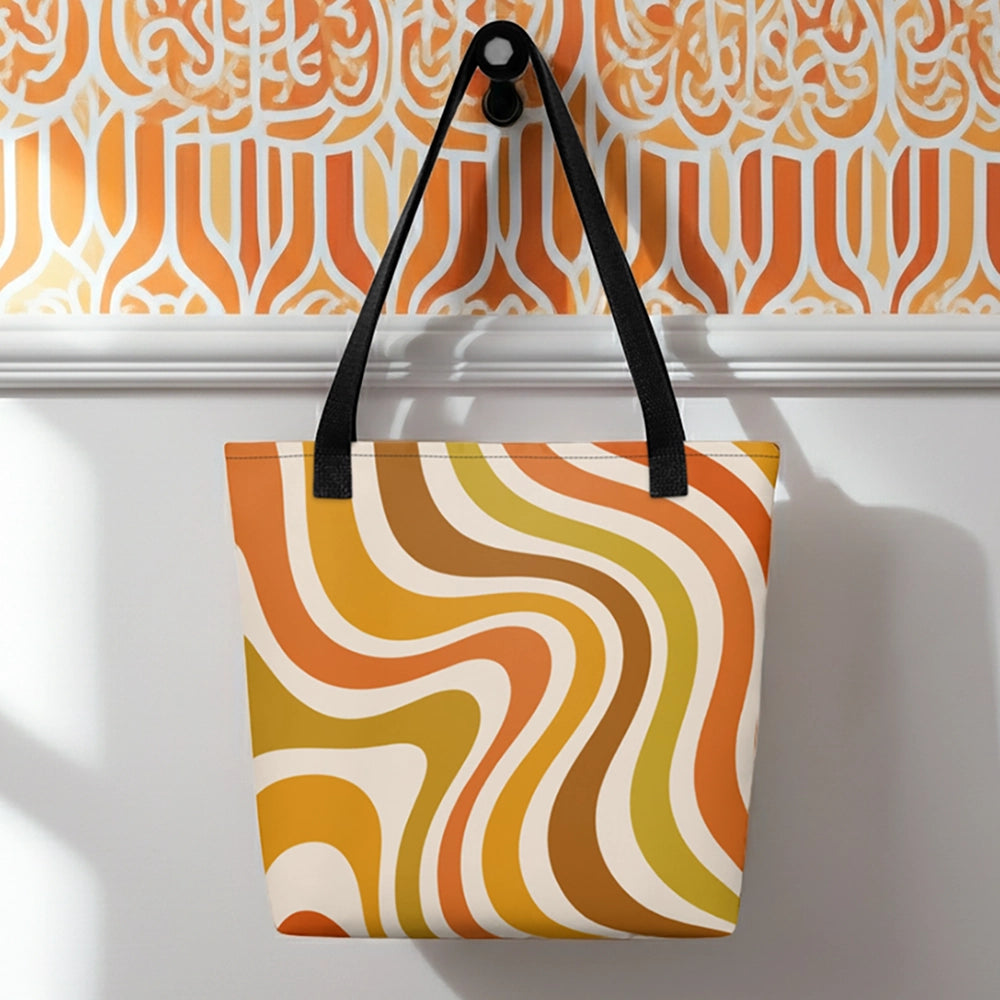 Retro 70s groovy wavy pattern in orange, mustard, brown, and cream printed on a durable polyester shoulder tote bag.