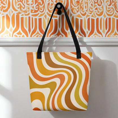 Retro 70s groovy wavy pattern in orange, mustard, brown, and cream printed on a durable polyester shoulder tote bag.