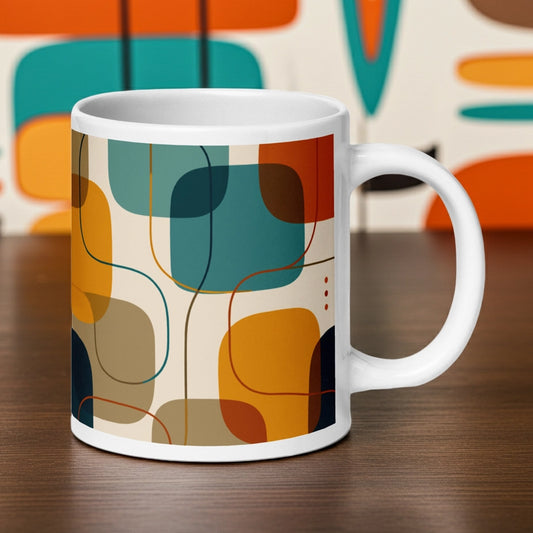 Retro geometric ceramic coffee mug featuring mid-century rounded squares and lines in teal, mustard yellow, and orange.