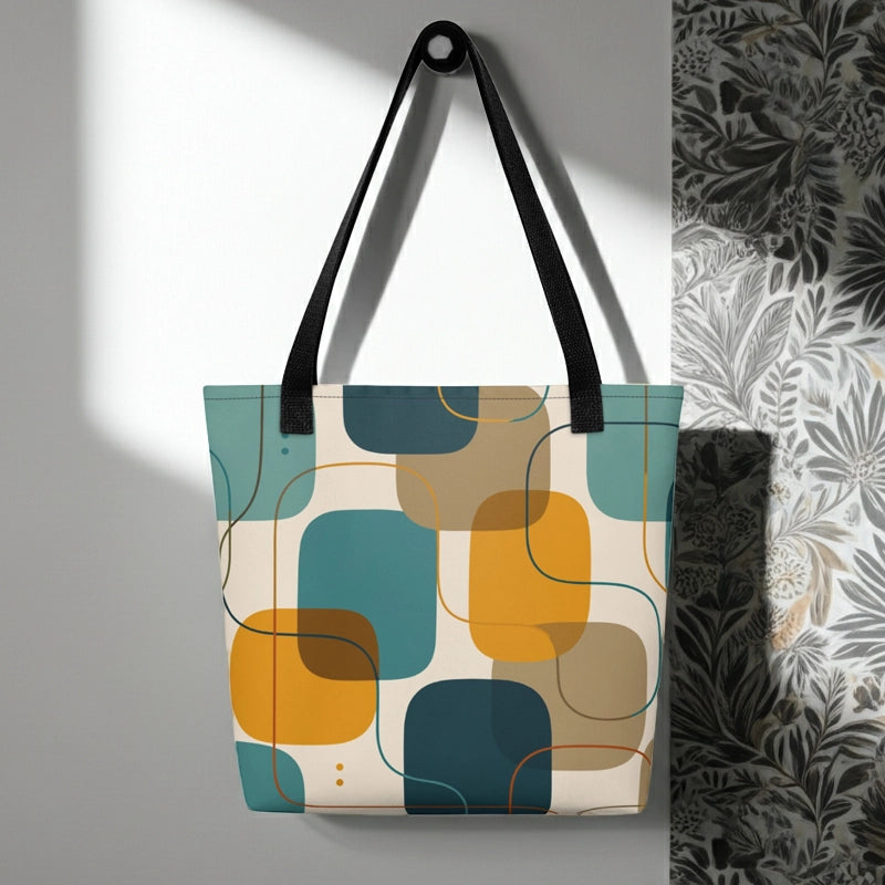 Retro geometric polyester tote bag featuring mid-century rounded squares and lines in teal, mustard yellow, and orange.