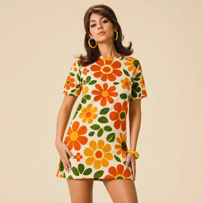 Vintage 70s retro flower power pattern with orange, yellow, and green daisy motifs printed on a comfy T-shirt dress.