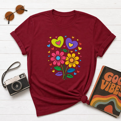 Retro 70s psychedelic flower power bouquet with vibrant pink and yellow daisies and hearts on a black graphic t-shirt.