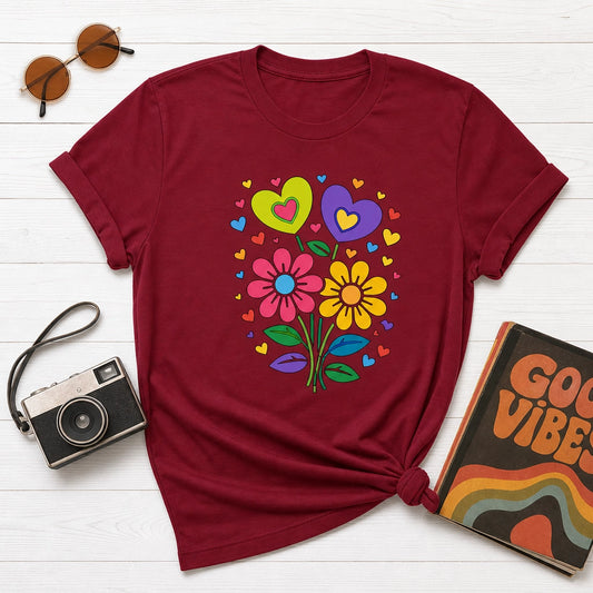 Retro 70s psychedelic flower power bouquet with vibrant pink and yellow daisies and hearts on a black graphic t-shirt.