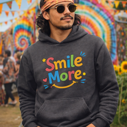 Smile More, bubbly lettering with a yellow sun-smile and pink heart on a black cozy hoodie.