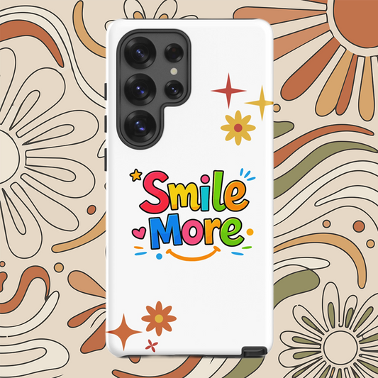 Smile More, bubbly lettering with a yellow sun-smile and pink heart on a black Samsung Galaxy phone case.