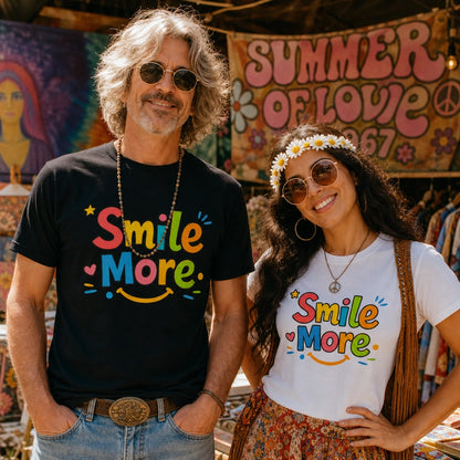 Smile More, bubbly lettering with a yellow sun-smile and pink heart on a black cotton t-shirt.