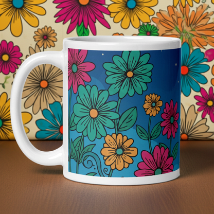 White glossy ceramic coffee mug featuring a vintage-style botanical illustration of colorful forest mushrooms and delicate wildflowers in earthy tones.