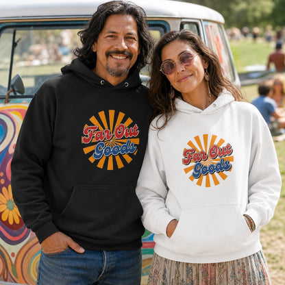 A man and a woman standing outdoors in front of a colorful van, wearing matching hoodies with a retro sunburst graphic that reads 'Far Out Goods.' The man wears a black hoodie, and the woman wears a white hoodie.