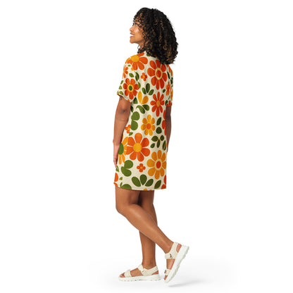Vintage 70s retro flower power pattern with orange, yellow, and green daisy motifs printed on a comfy T-shirt dress.