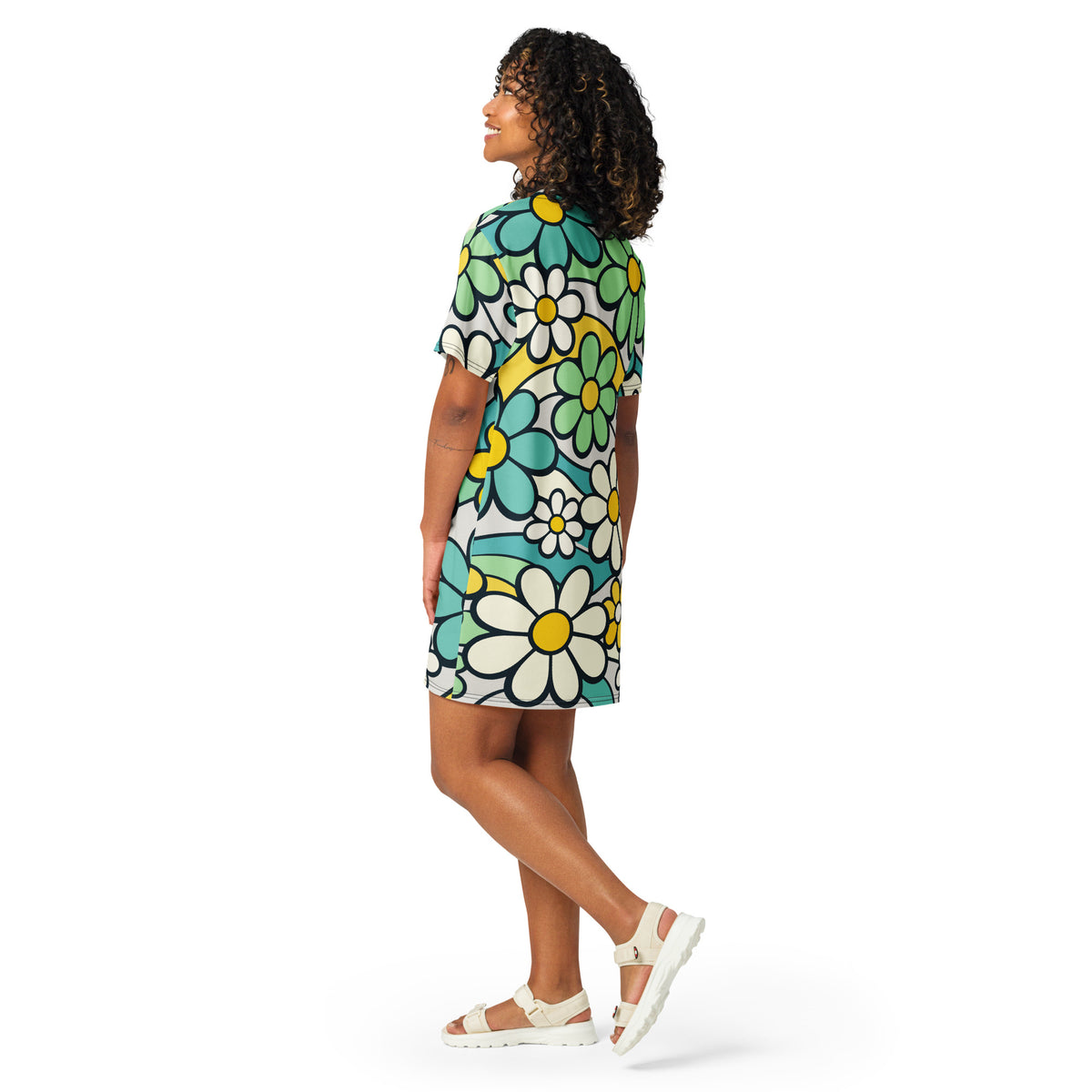 Retro 70s style t-shirt dress featuring a vibrant pattern of blue, yellow, and green flowers with wavy lines