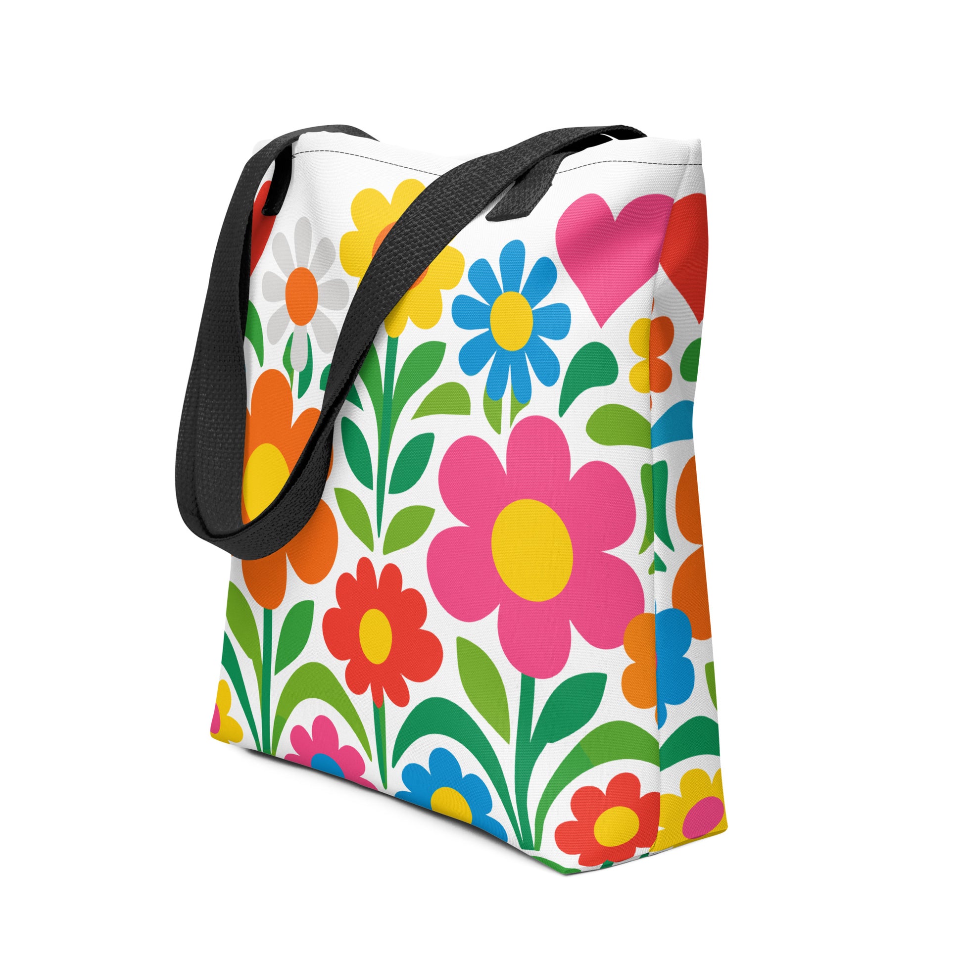 Vibrant 70s style retro flower power design with colorful daisies and hearts printed on a white tote bag. faroutgoods.