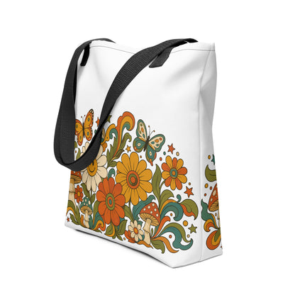 Retro 70s psychedelic tote bag featuring smiley daisies, red spotted mushrooms, and colorful butterflies on black.