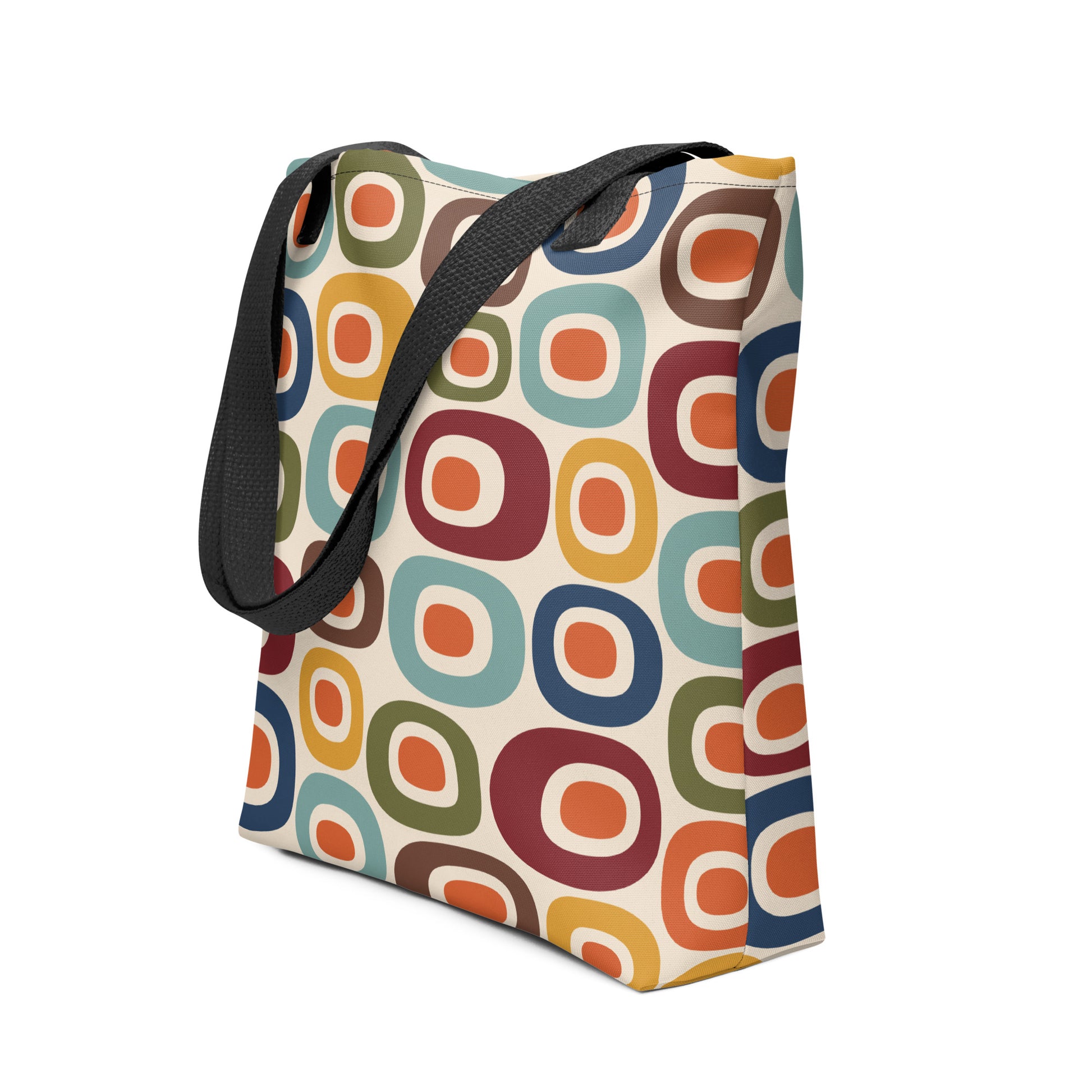Retro 1970s mid-century modern geometric oval pattern tote bag printed with colorful mustard, orange, teal, and navy shapes