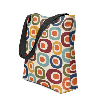Retro 1970s mid-century modern geometric oval pattern tote bag printed with colorful mustard, orange, teal, and navy shapes