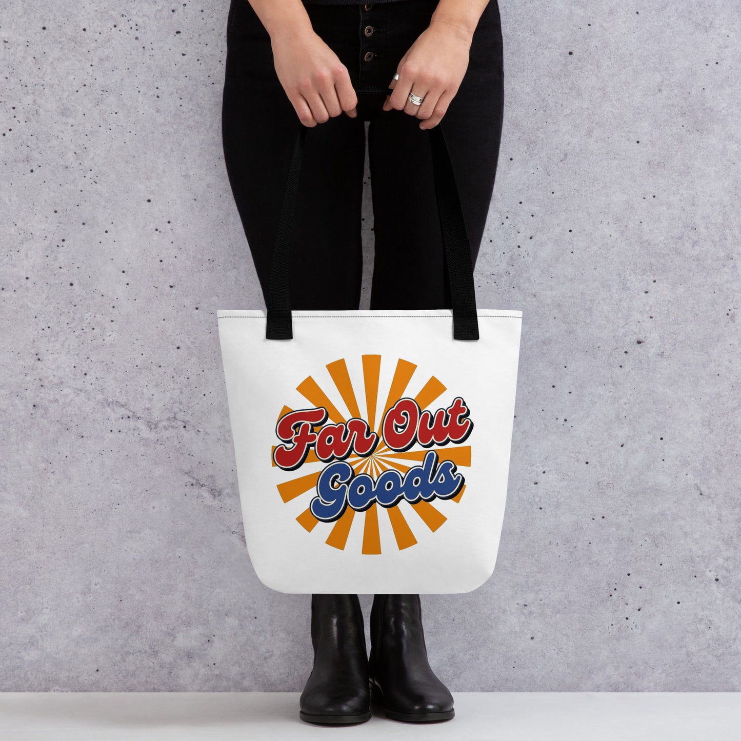 Retro orange sunburst design with Far Out Goods text in red and blue script on a black cotton tote bag.