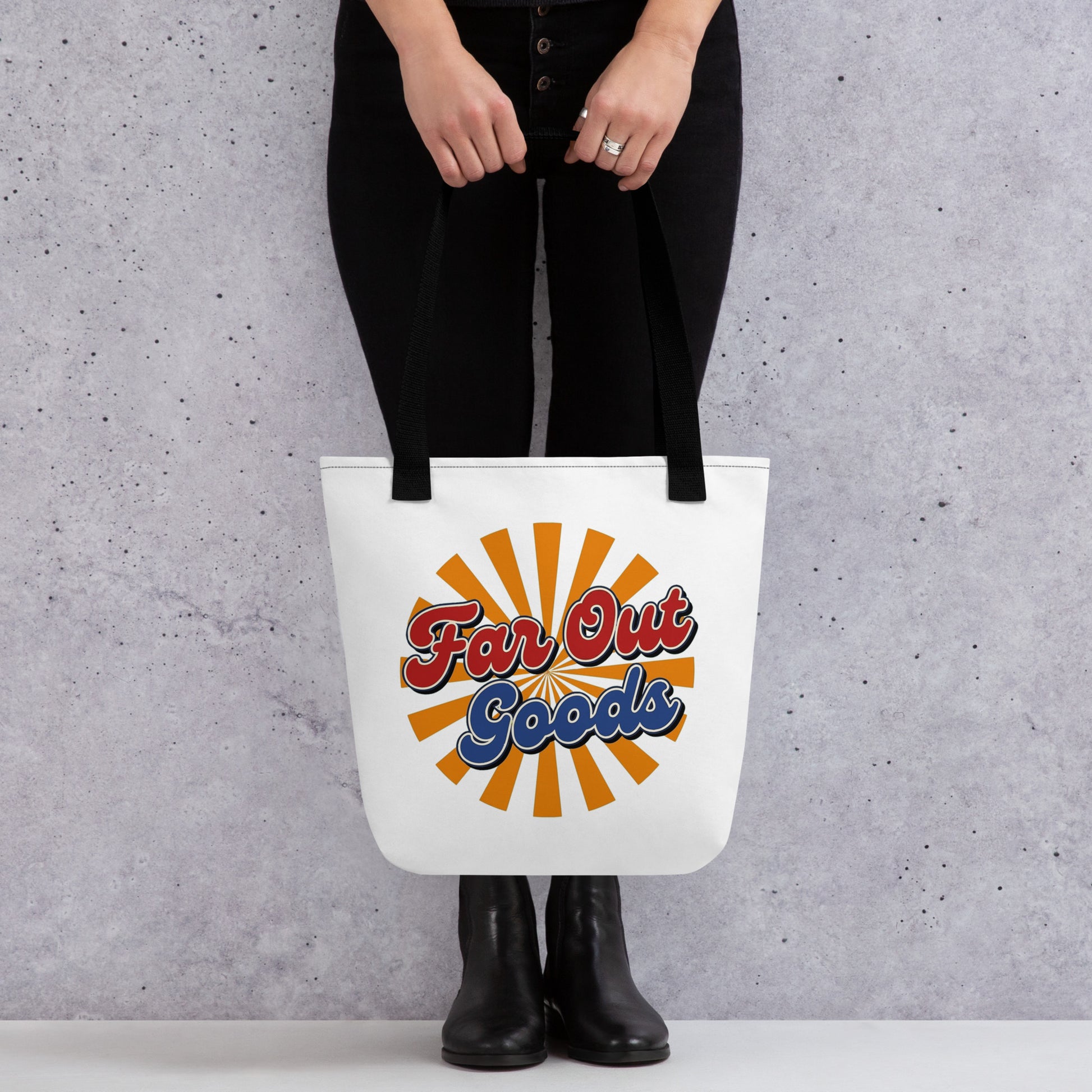 Retro orange sunburst design with Far Out Goods text in red and blue script on a black cotton tote bag.