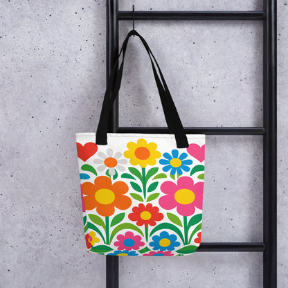 Vibrant 70s style retro flower power design with colorful daisies and hearts printed on a white tote bag. faroutgoods.