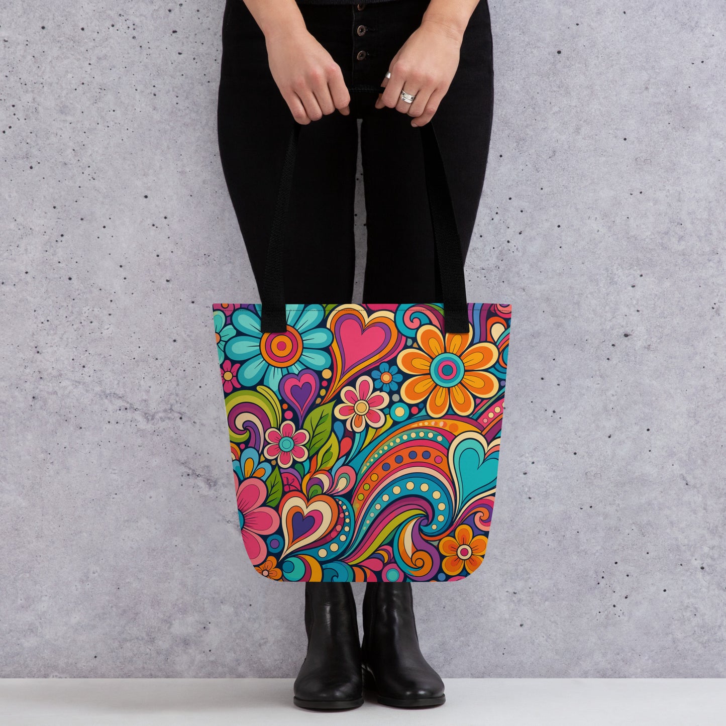 Polyester tote bag featuring a colorful 70s psychedelic doodle pattern of groovy flowers, retro swirls, and hearts.