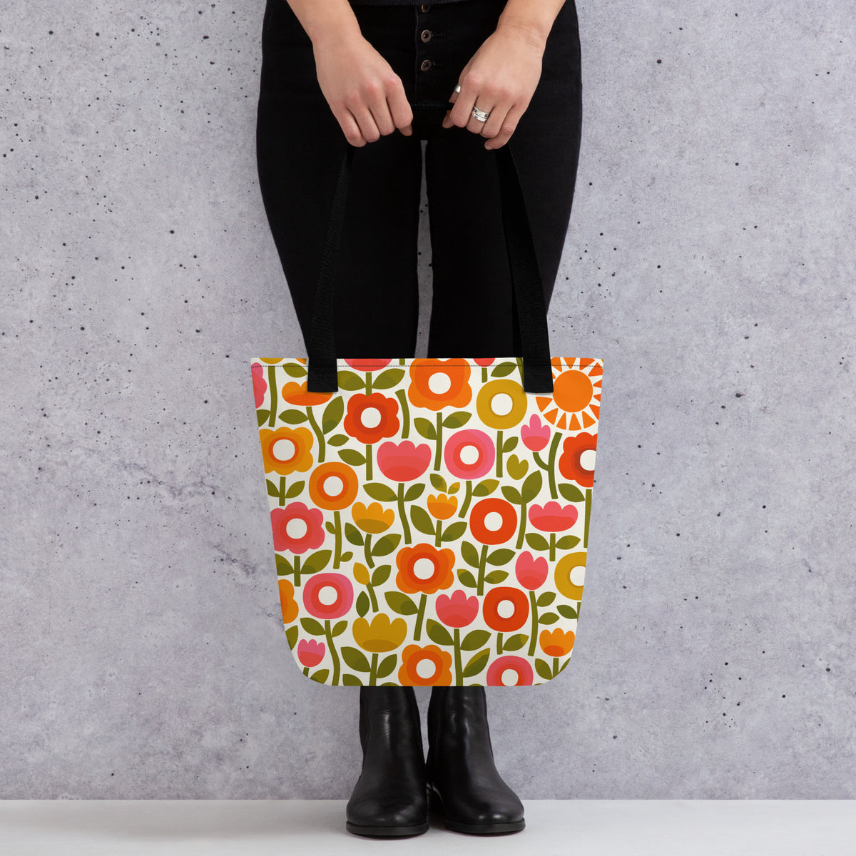 Retro 1970s flower power pattern tote bag featuring geometric orange, pink, and yellow flowers with green leaves
