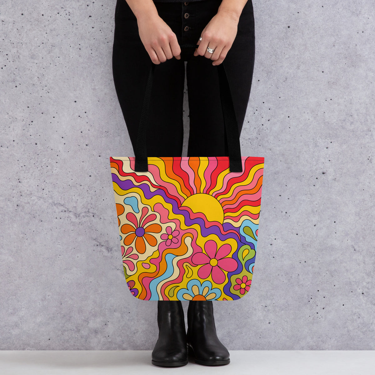 Vibrant 1970s psychedelic tote bag featuring a wavy retro sunburst sunset surrounded by colorful groovy flowers.