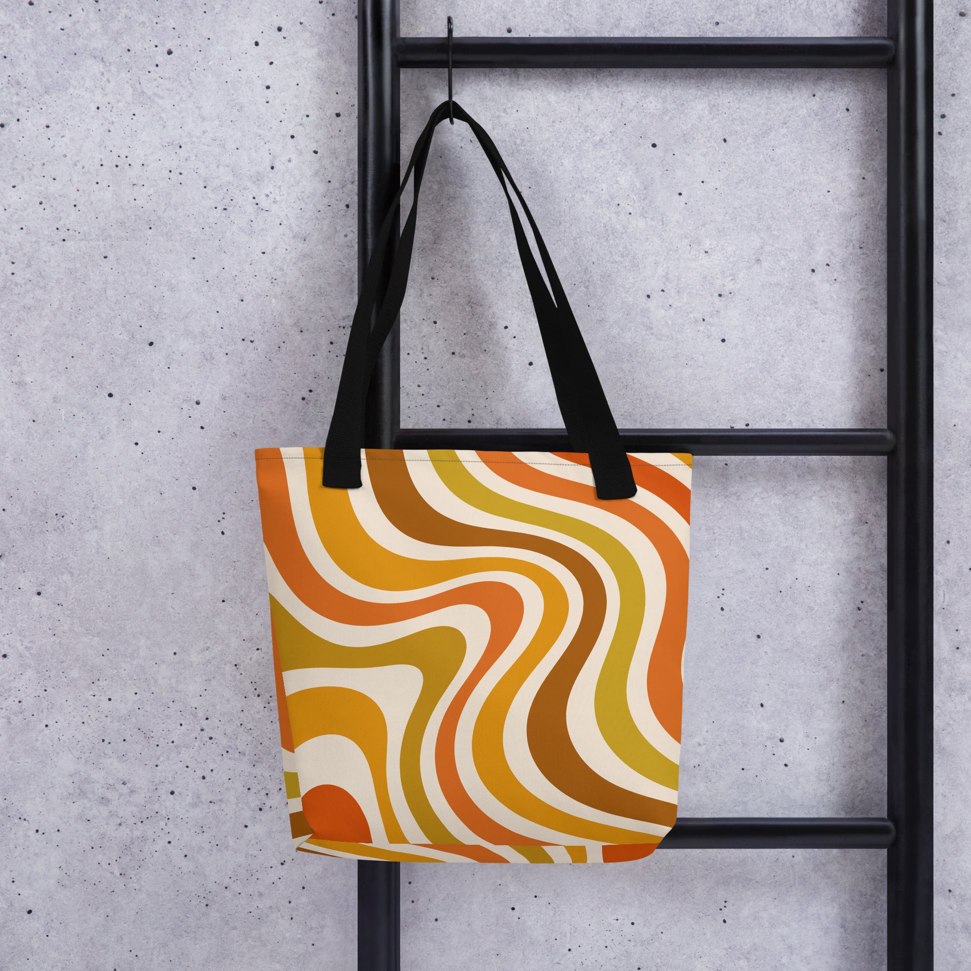 Retro 70s groovy wavy pattern in orange, mustard, brown, and cream printed on a durable polyester shoulder tote bag.