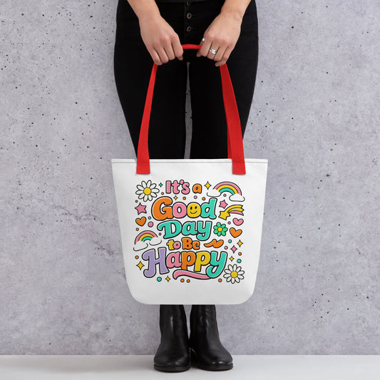 Retro 70s tote bag design with "It's a Good Day to Be Happy" text, rainbows, and daisies on a black background.