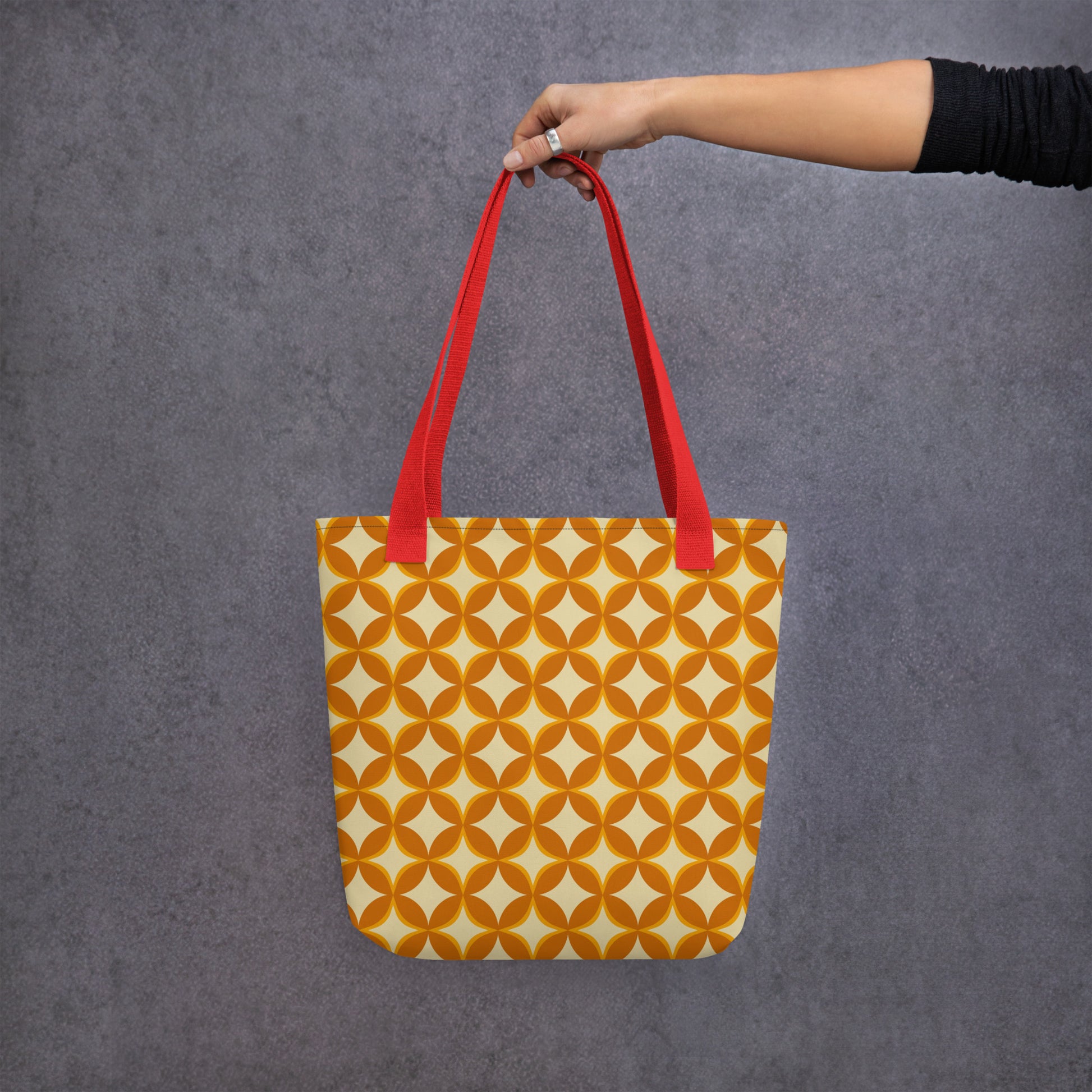 Repeating geometric pattern of interlocking orange and cream circles and stars in a 1970s retro vintage style.