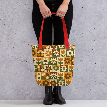 Polyester tote bag featuring a 70s retro floral tile pattern in orange, brown, and green from Far Out Goods.
