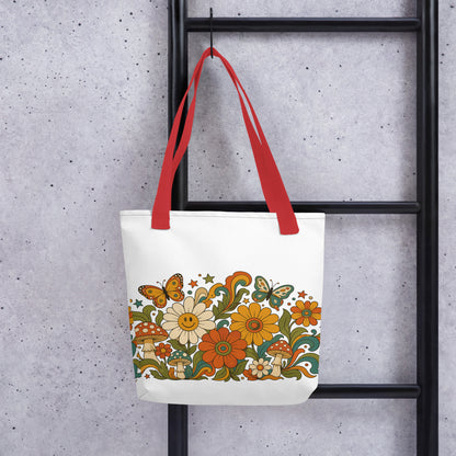 Retro 70s psychedelic tote bag featuring smiley daisies, red spotted mushrooms, and colorful butterflies on black.