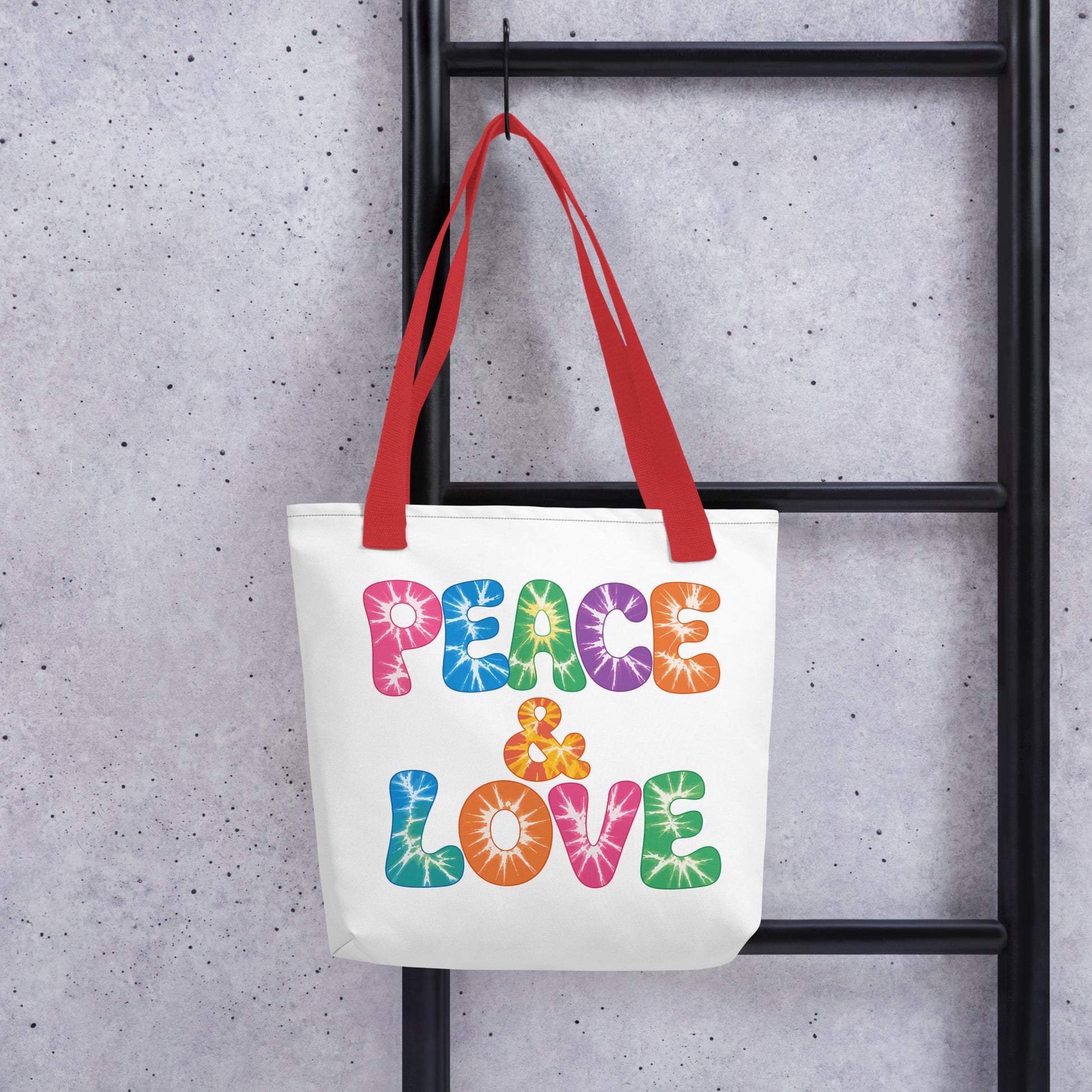 Retro tie-dye Peace and Love lettering printed on a reusable black polyester tote bag with vibrant 60s rainbow font.