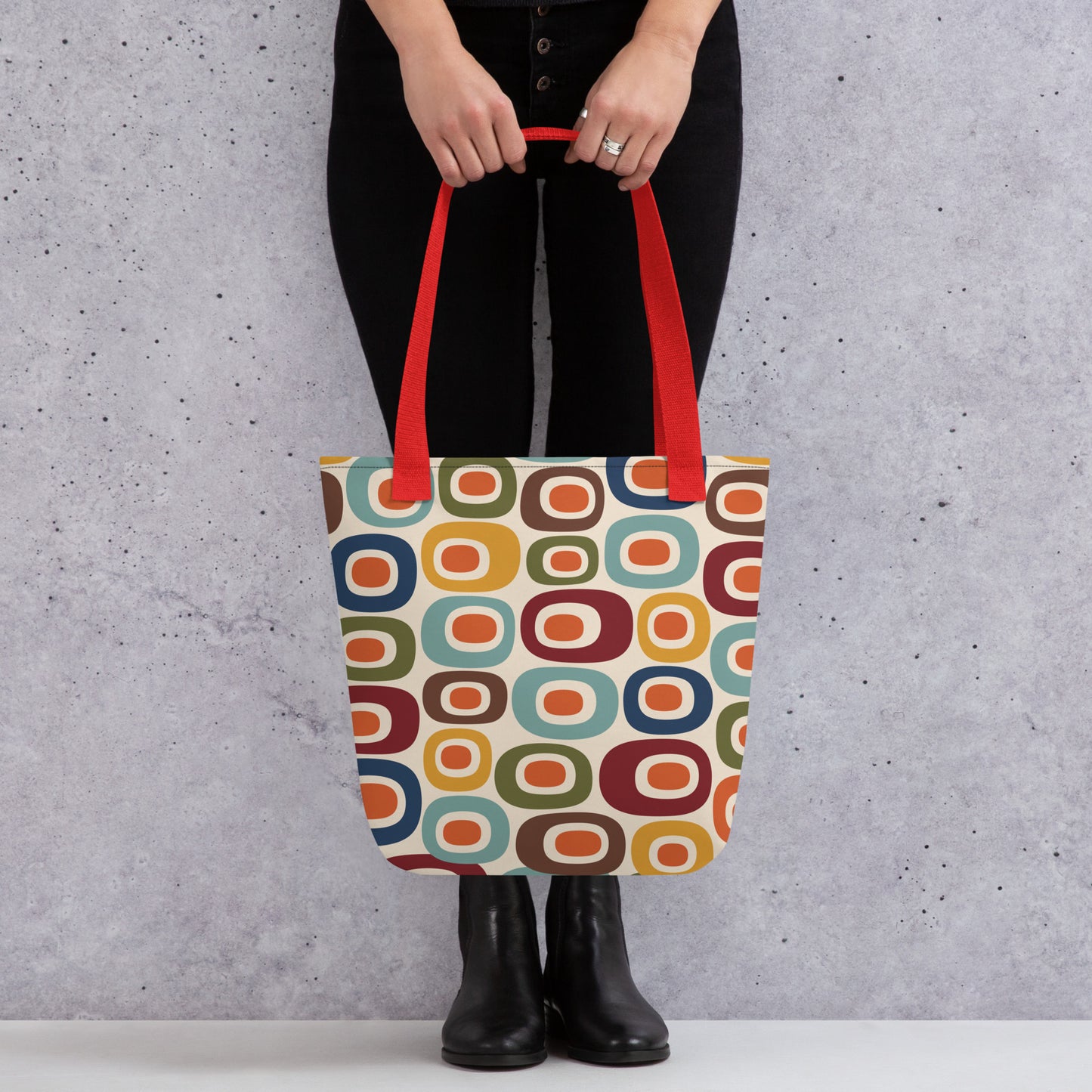 Retro 1970s mid-century modern geometric oval pattern tote bag printed with colorful mustard, orange, teal, and navy shapes