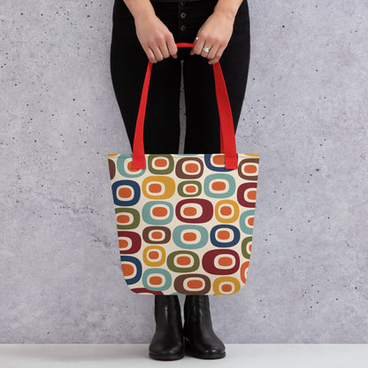 Retro 1970s mid-century modern geometric oval pattern tote bag printed with colorful mustard, orange, teal, and navy shapes