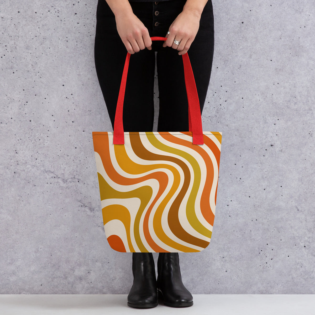 Retro 70s groovy wavy pattern in orange, mustard, brown, and cream printed on a durable polyester shoulder tote bag.