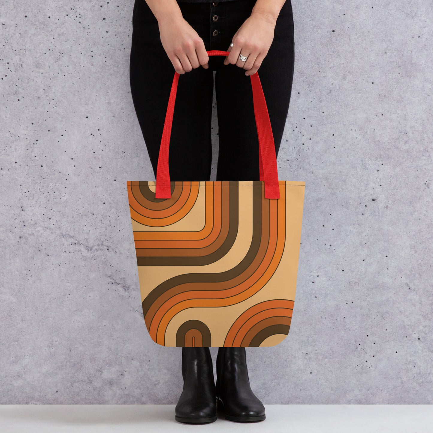 Retro 70s curved stripe pattern in earth tones, brown, and orange printed on a durable polyester everyday tote bag.