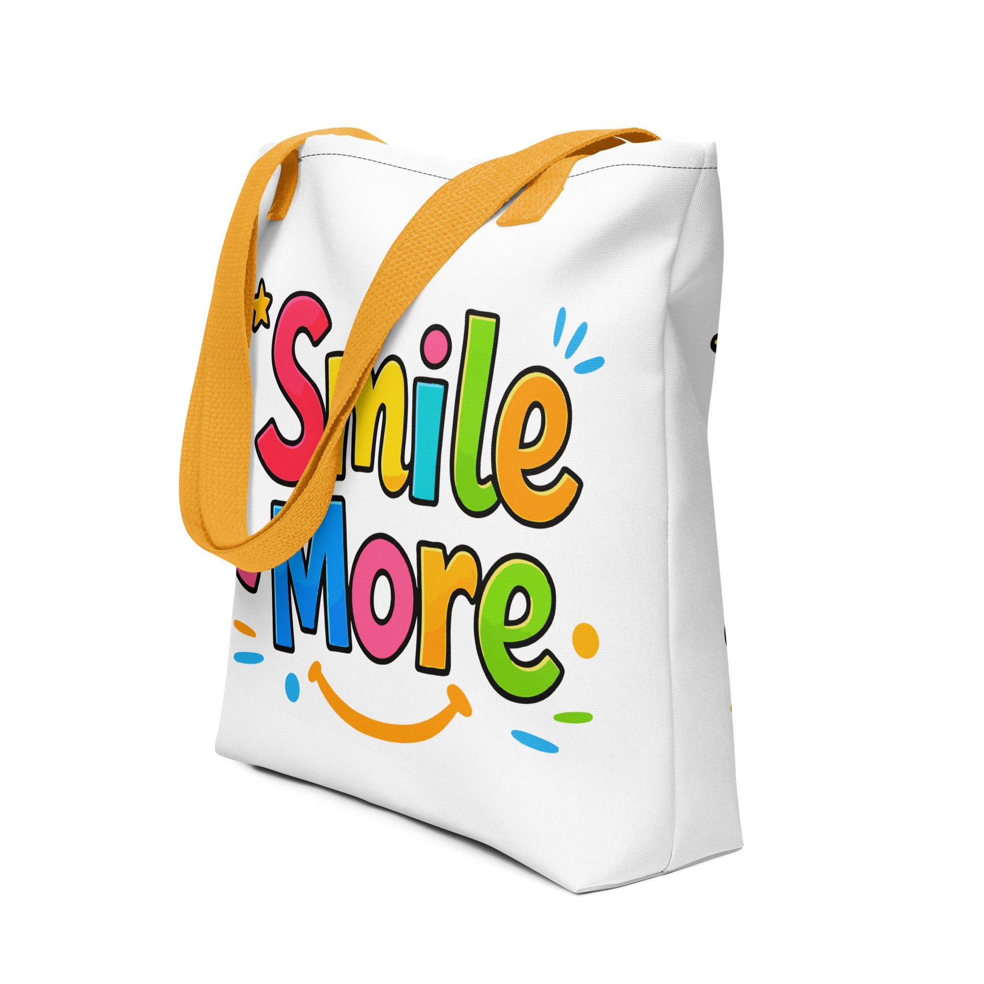 Colorful bubbly text reading "Smile More" with a yellow sun-smile and pink heart on a black canvas tote bag.