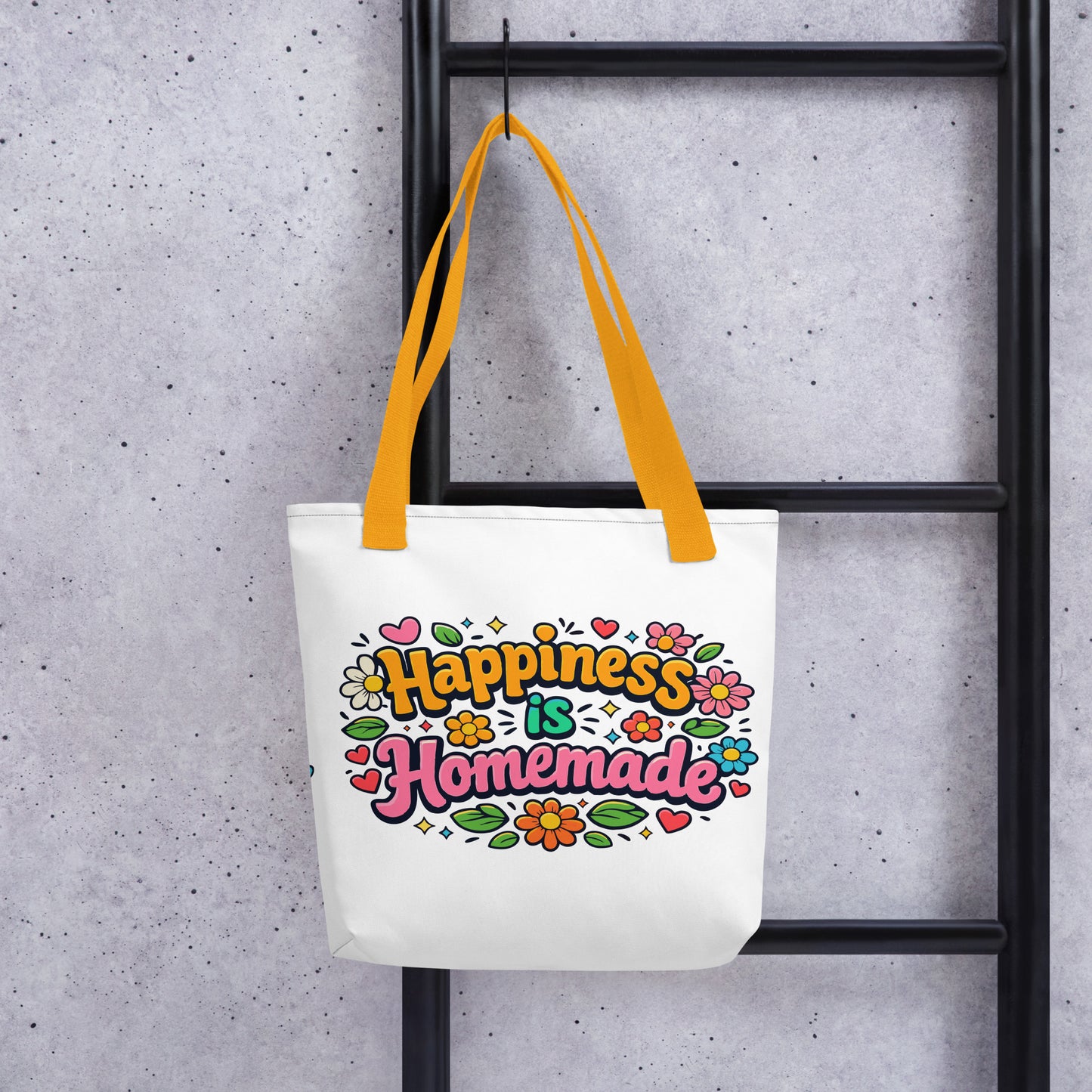 Retro tote bag featuring 'Happiness is Homemade' text with 1970s style flowers and hearts on a black background.