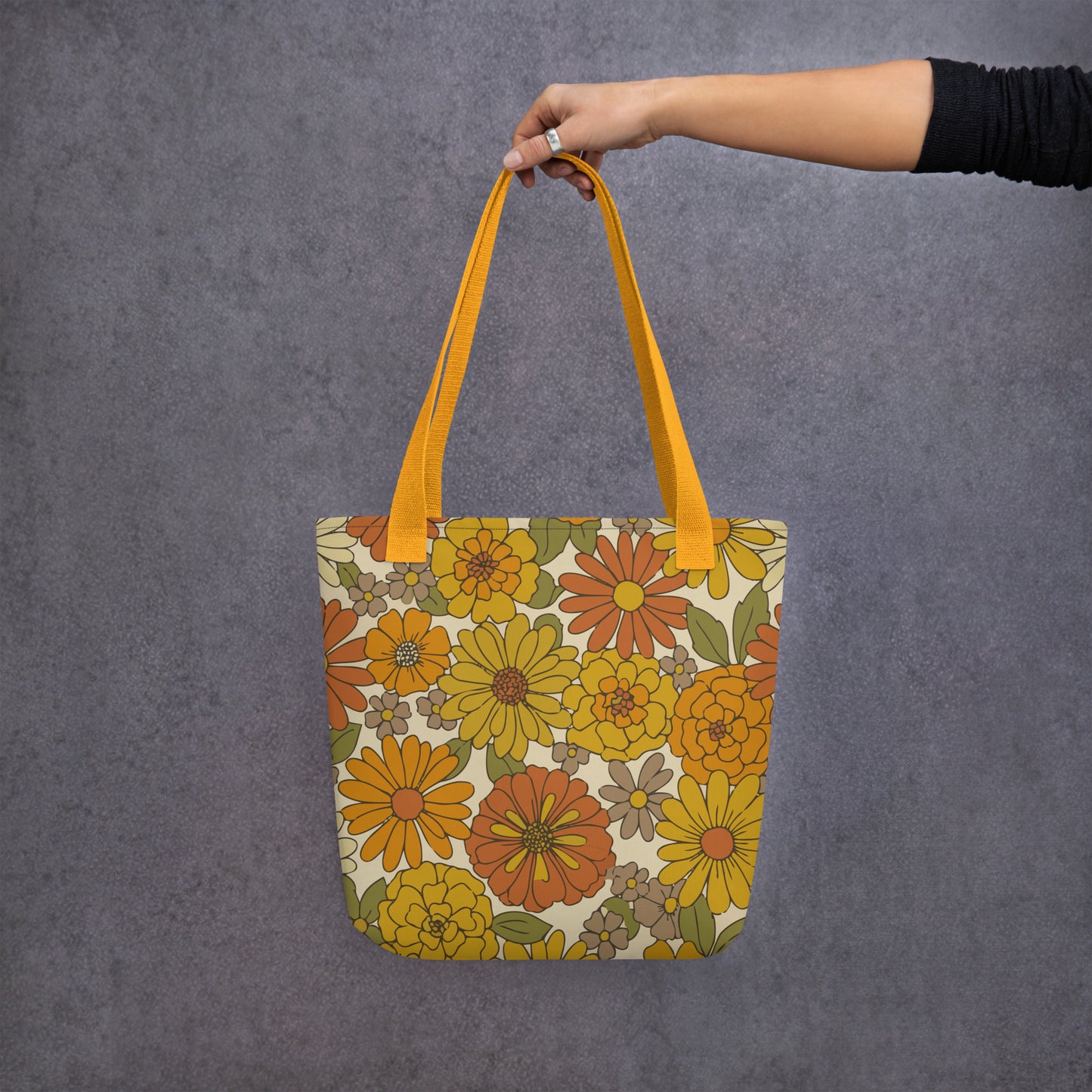 All-over retro floral pattern tote bag in warm mustard yellow, burnt orange, and green flower power design.