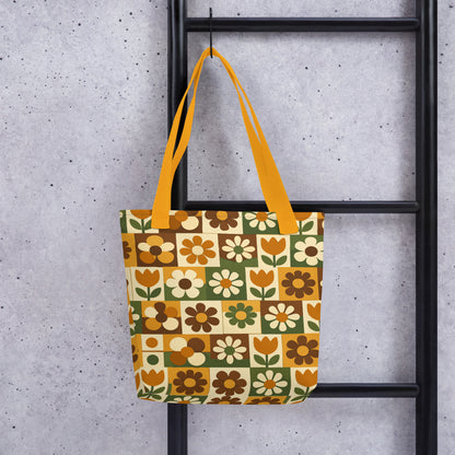 Polyester tote bag featuring a 70s retro floral tile pattern in orange, brown, and green from Far Out Goods.
