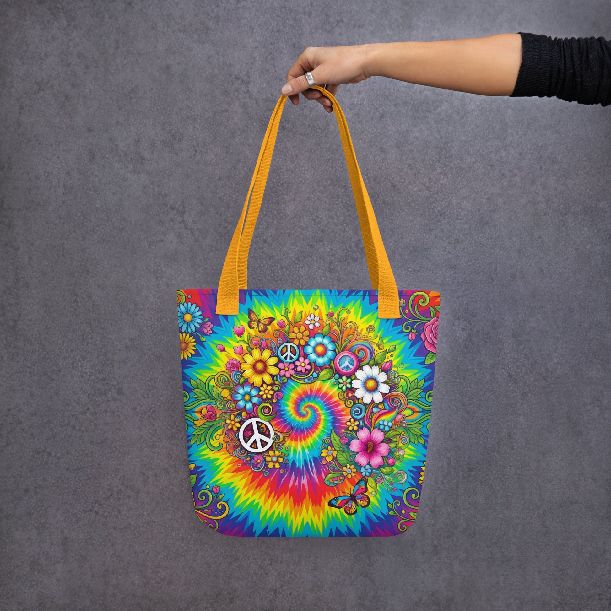 Vibrant psychedelic tie dye polyester tote bag featuring retro floral designs, butterflies, and white peace signs.