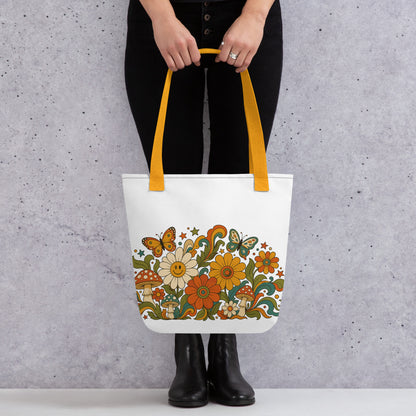 Retro 70s psychedelic tote bag featuring smiley daisies, red spotted mushrooms, and colorful butterflies on black.