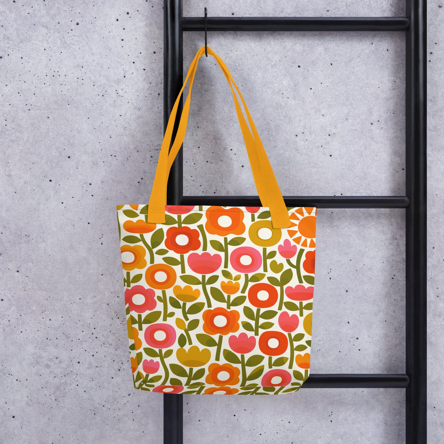 Retro 1970s flower power pattern tote bag featuring geometric orange, pink, and yellow flowers with green leaves