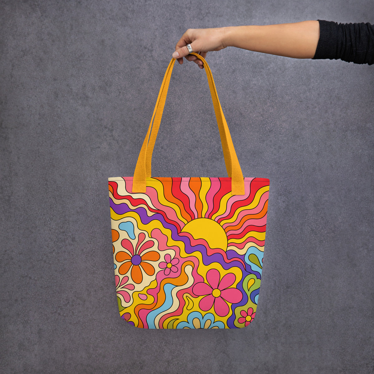 Vibrant 1970s psychedelic tote bag featuring a wavy retro sunburst sunset surrounded by colorful groovy flowers.