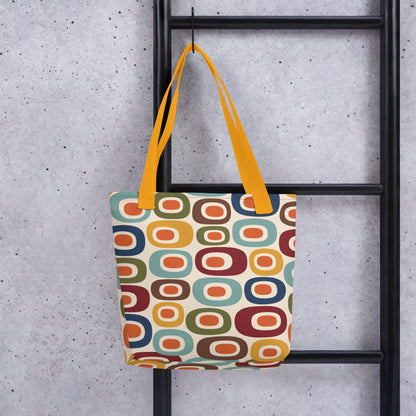 Retro 1970s mid-century modern geometric oval pattern tote bag printed with colorful mustard, orange, teal, and navy shapes